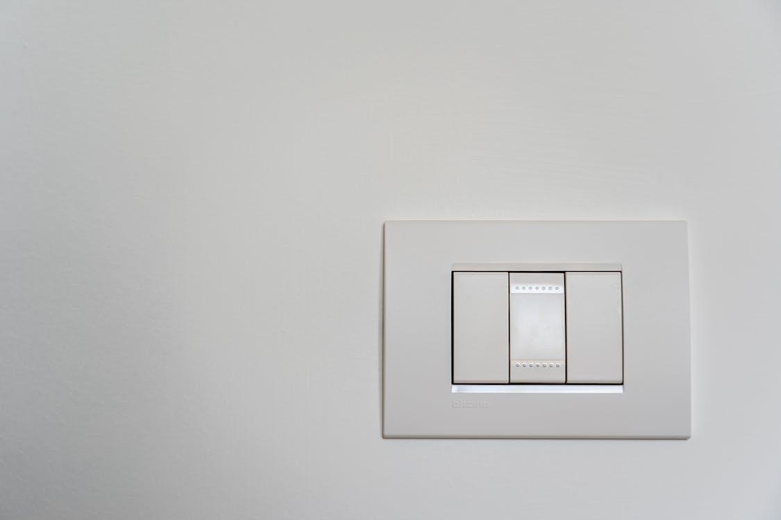 Free White Light Switch on White Painted Wall Stock Photo